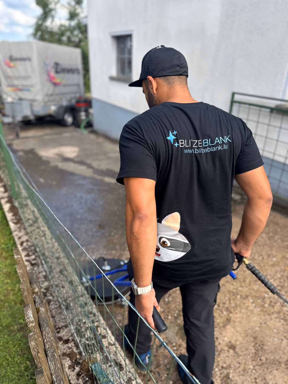 Blitzeblank team member in a company shirt with raccoon logo during a cleaning job